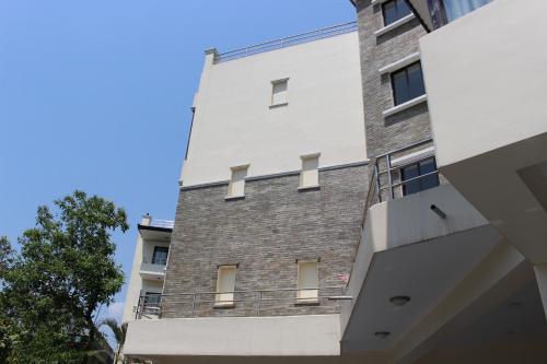 a tall brick building with a balcony at Tuki Resort Pokhara in Pokhara