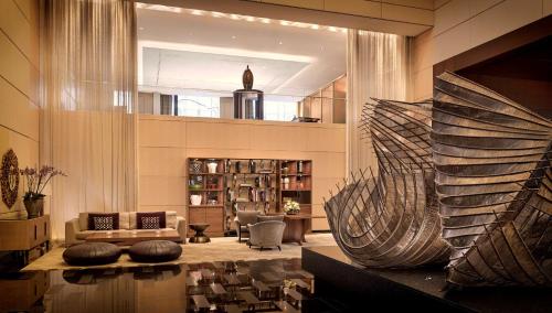 a living room with a couch and a fireplace at Park Hyatt Zurich – City Center Luxury in Zürich