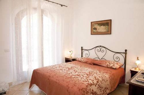 a bedroom with a bed and a large window at Villa Palumbo in Positano