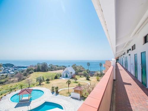 a view from the balcony of a building with a swimming pool at Resort Hotel Umibe no Kajuen in Konan
