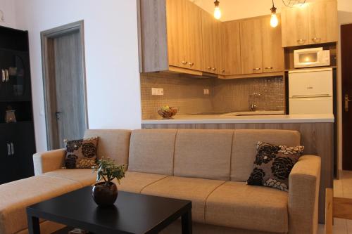 a living room with a couch and a table at Stelianas Apartment in Zakynthos Town