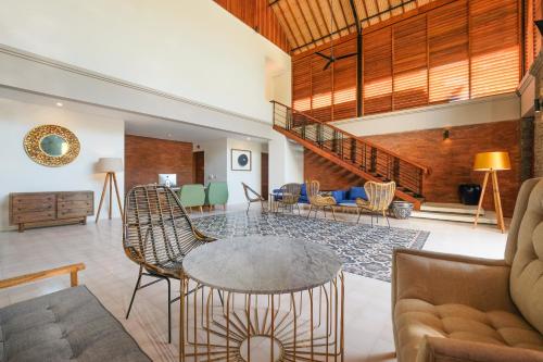 a living room with a table and chairs at Sagara Candidasa by AHM in Candidasa