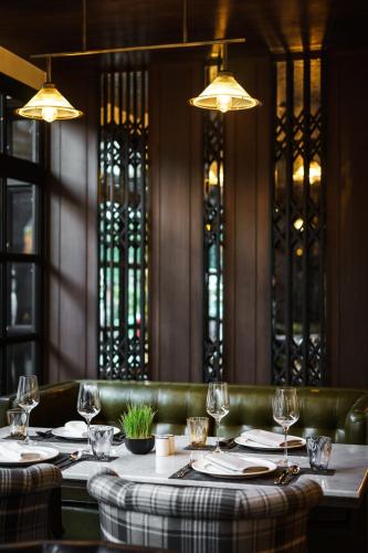 a dining room with a table with wine glasses at Tastoria Collection Sukhumvit in Bangkok