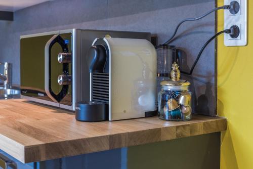 a microwave sitting on top of a wooden counter top at Gite "le millésime" in Épernay