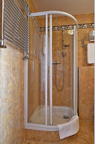 a shower with a glass door in a bathroom at LH Hotel Dvořák Tábor Congress & Wellness in Tábor