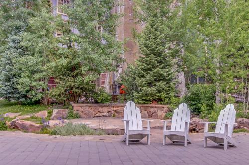 two white chairs and a table in a garden at Copper Mountain in Frisco