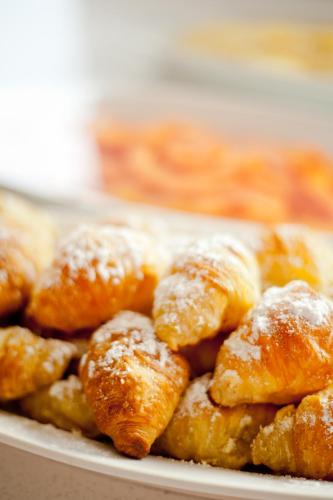 a plate of doughnuts covered in powdered sugar at Toshari Lodge in Okaukuejo