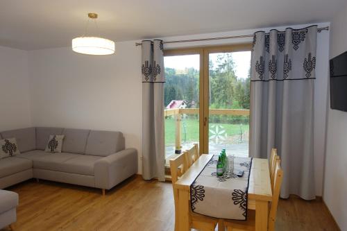 a living room with a couch and a table at Willa Zaolzie in Istebna