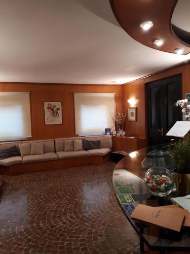 a living room with a couch and a glass table at Manuelina Taste Hotel in Recco