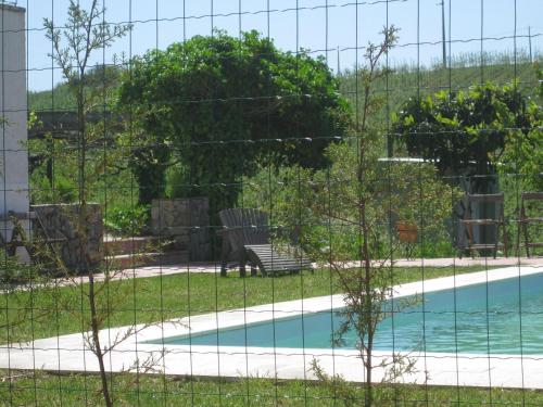 a fence around a swimming pool with a bench at Casa do Caseiro in Sobrena