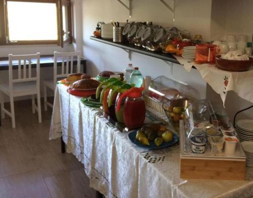 a long table with plates of food on it at La Duchessa e Il Contadino in Vieste