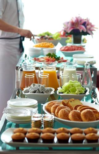 a buffet of food on a table with food at Dorsett Kwun Tong, Hong Kong in Hong Kong