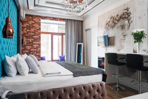 a bedroom with a bed and a brick wall at Theatre Boutique Apart-Hotel in Kyiv