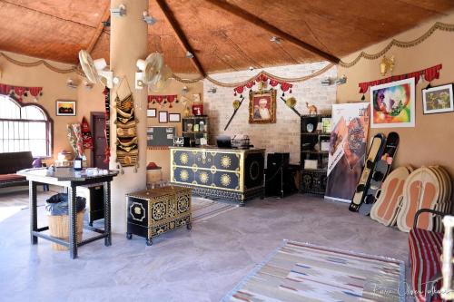 a room filled with furniture and a room with a room at Arabian Oryx Camp in Shāhiq