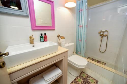 a bathroom with a sink and a toilet and a shower at Puppet rooms in Corfu