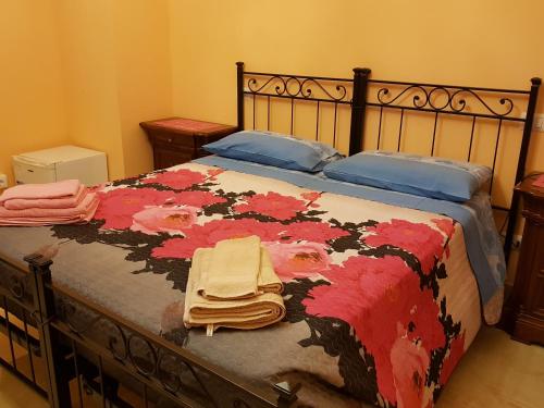 ローマにあるThe Sun Houseのベッドルーム1室(花柄の毛布付きのベッド1台付)