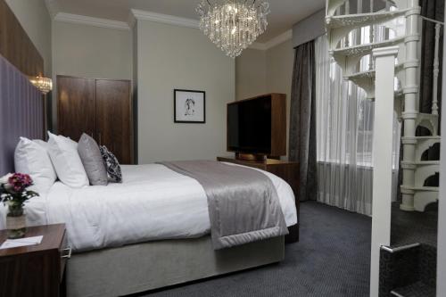 a hotel room with a bed and a television at The Croft Hotel in Darlington