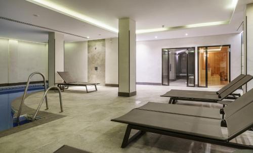 a gym with two tables and a swimming pool at Ilunion Hacienda de Mijas in Mijas