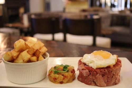 a plate of food with an egg and fries at Heritage Park Pontypridd, Trademark Collection by Wyndham in Pontypridd