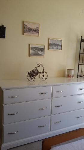 a chest of drawers with a bike on top of it at Fiora Villas in Trapezaki