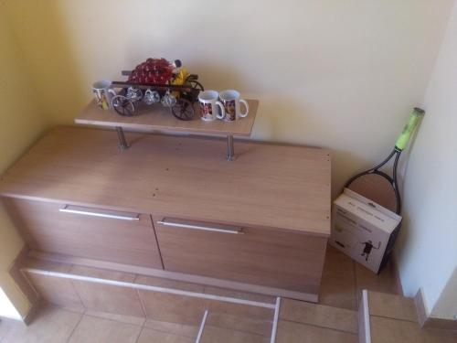a wooden dresser with a shelf on top of it at Casa Ovi și Simo in Haţeg