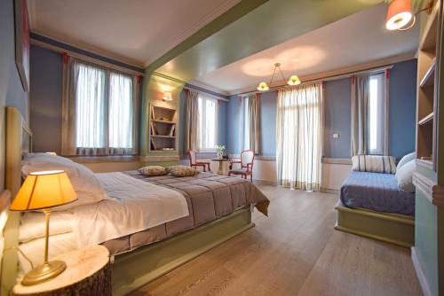 a bedroom with a bed and a table and chairs at Puppet rooms in Corfu