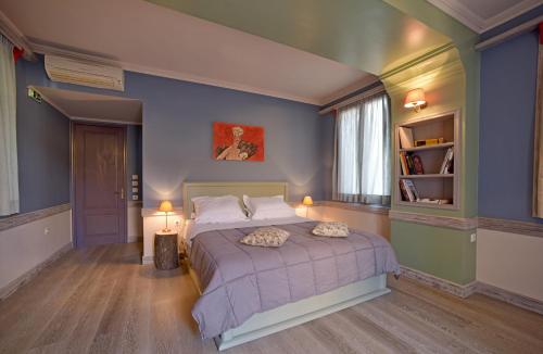 a bedroom with a bed and a lamp at Puppet Guesthouse in Corfu Town