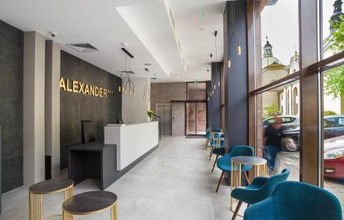 a lobby of a restaurant with blue chairs at Hotel Alexander in Kraków