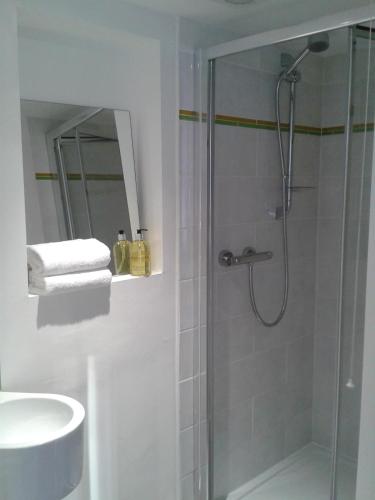 a bathroom with a shower and a sink at Warwick Market Place Apartment in Warwick