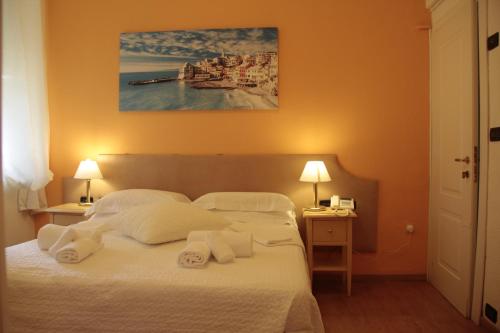 a bedroom with a bed with white sheets and pillows at Hotel Argentina in Santa Margherita Ligure