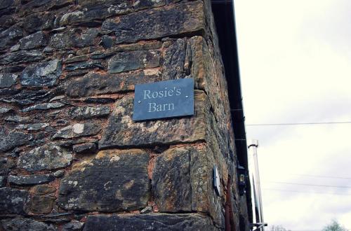 a sign on the side of a stone building at Rosie's Barn in Penrith