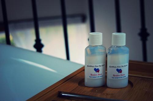 two bottles of liquids sitting on a table at Rosie's Barn in Penrith