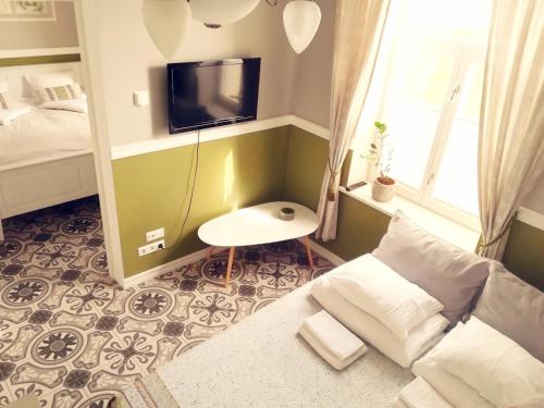 a small living room with a couch and a tv at Villa Marienholm in Haapsalu