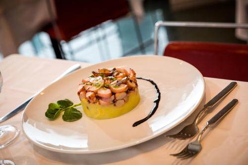 a white plate with a dessert on a table at Waldorf Palace Hotel in Cattolica