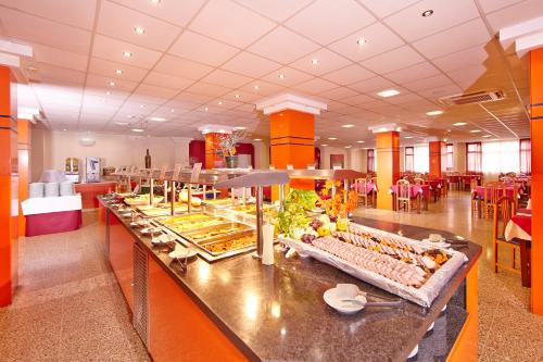 a buffet line with food on it in a restaurant at MLL Caribbean Bay in El Arenal