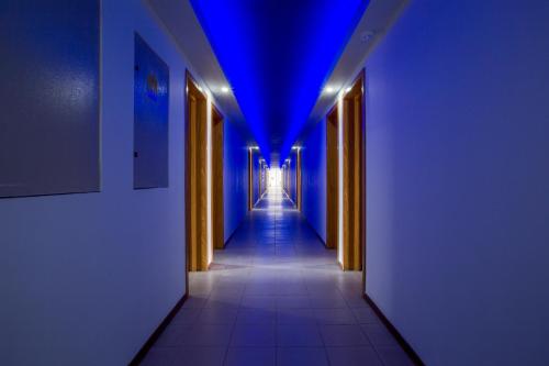 a hallway with blue lights in a building at Hotel Apollo in Mamaia