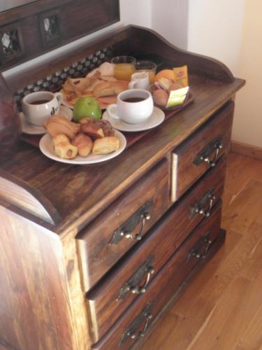 a wooden counter with two plates of food on it at Koustenis Village in Dhimitsana
