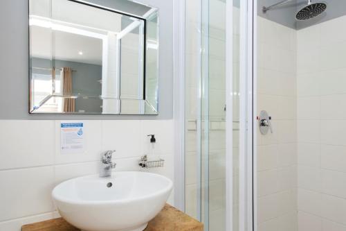 a bathroom with a sink and a shower at Cape St Francis Resort in Cape St Francis