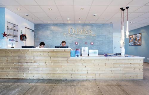 two people sitting at the counter of a restaurant at Résidence Odalys Front de Neige in Plagne Villages