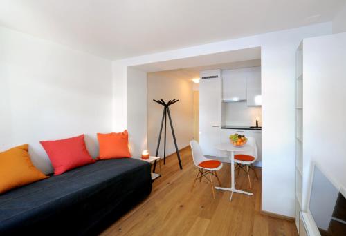 a living room with a couch and a table at Hotel Sternen in Lenk