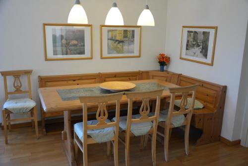 a dining room with a wooden table and chairs at Casa Bellavista 1 in Colico