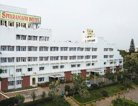 ein großes weißes Gebäude mit einem Schild drauf in der Unterkunft Sivaranjani Hotel in Hosur