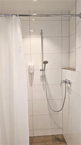 a bathroom with a shower with a shower curtain at Motel Espenhof in Ladbergen