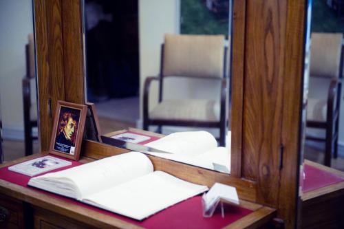 a mirror on a desk with books and a picture at Chopin Boutique in Warsaw