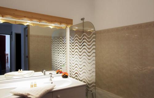 a bathroom with a sink and a shower at Résidence Odalys Les Sybelles in Saint-Sorlin-dʼArves