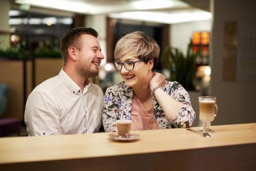 a man and a woman sitting at a table at Vestil Hotel in Piotrków Trybunalski