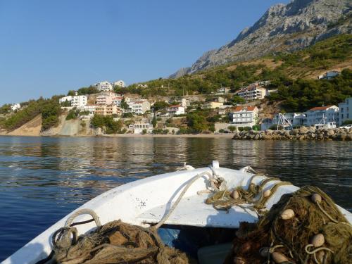 a boat on a body of water with a town at Apartments Tom in Mimice