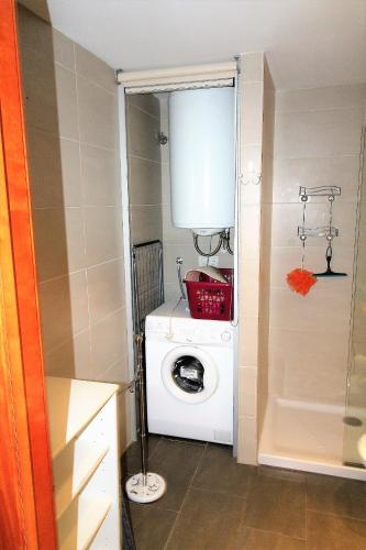 a washer and dryer in a small bathroom at Marina Beach Hollidays Mimosa in Empuriabrava