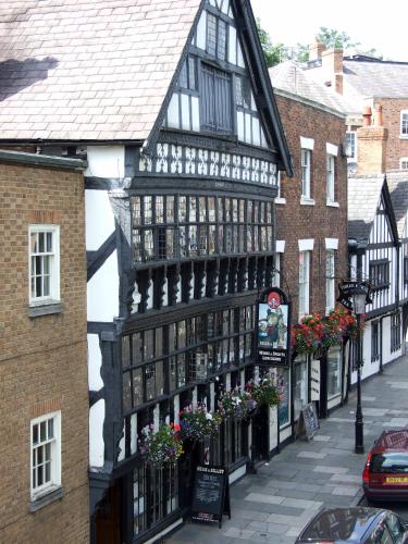 an old black and white building on a street at Gamul Place - Quiet City Centre in Chester