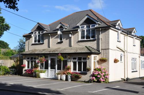 a house with flowers in front of it at Walcot House in Fawley